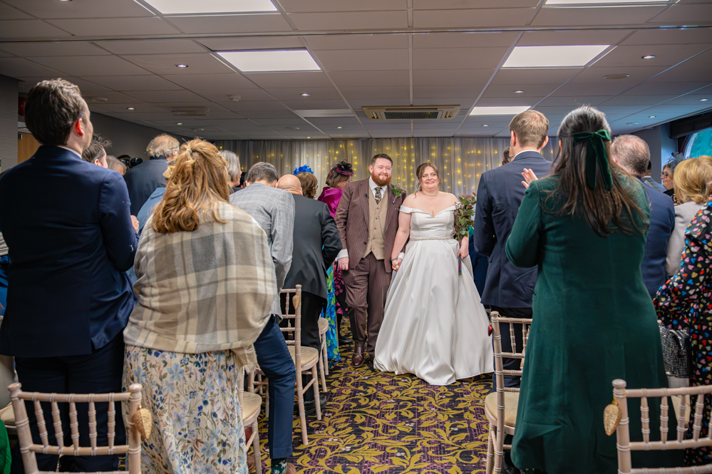bride and groom walking down the aisle.