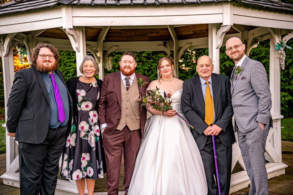 bride, groom with father of the bride, his girlfriend and brides two brothers with bandstand behind them