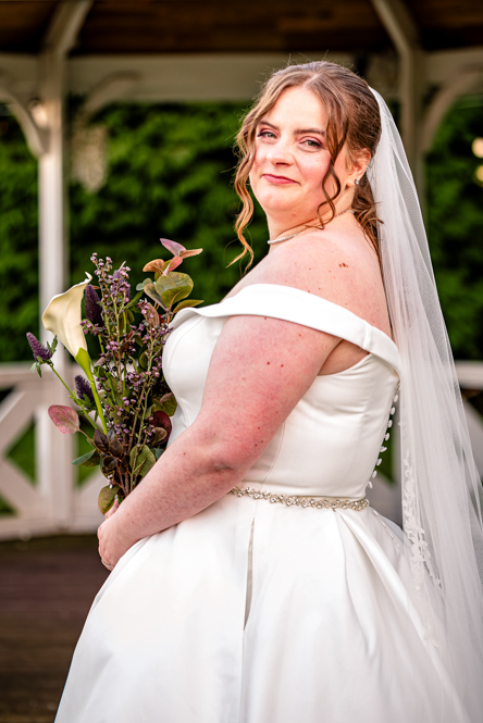 Side portrait of the bride holding her bouquet at a Greater Manchester wedding
