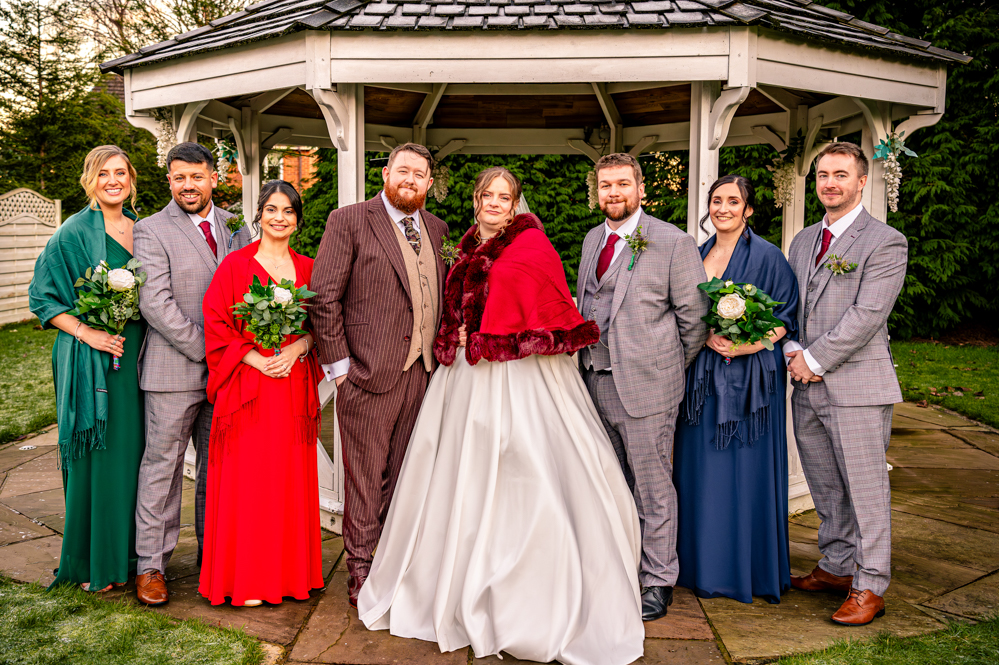 Bridal Party with bandstand behind them taken by Manchester Photographer Wedding Rebekah Morecroft