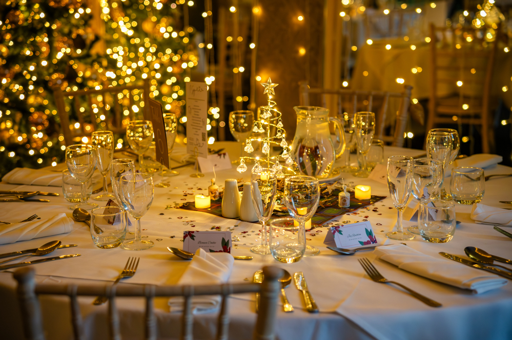 Wedding table decorations with chandelier style light up Christmas tree as centre piece