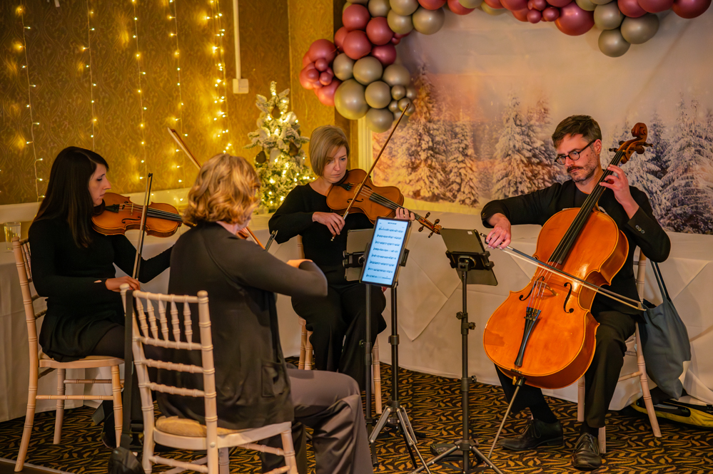 3 women violinists and a man cello player