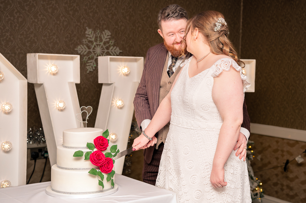 Bride and groom cutting the wedding cake
