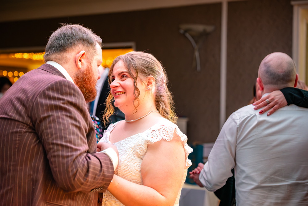 Bride and groom’s first dance with guests also dancing