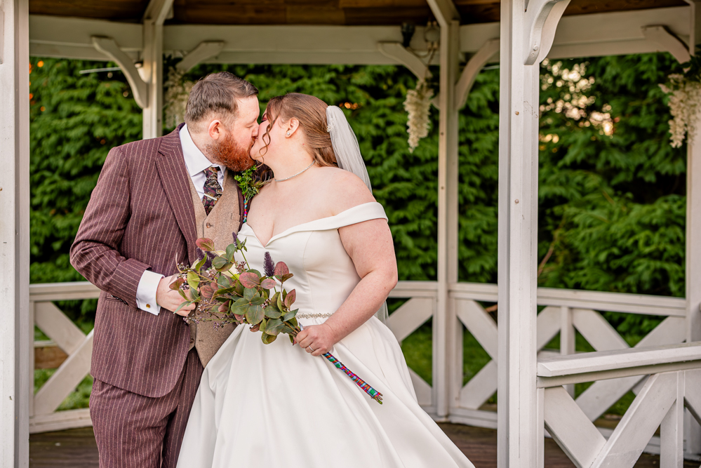 Bride and groom sharing a kiss, natural moment together at Everglades Hotel, Widnes, Cheshire