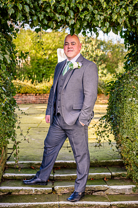 Groom under a leaf shaped arch