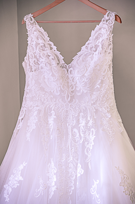 Wedding dress hanging from hanger