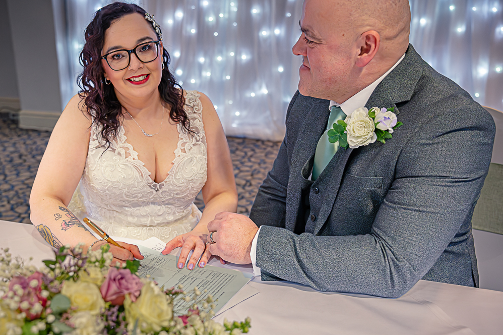 Bride signing the register (posed)