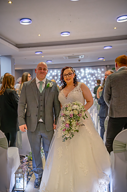 Bride and Groom walking down the aisle.