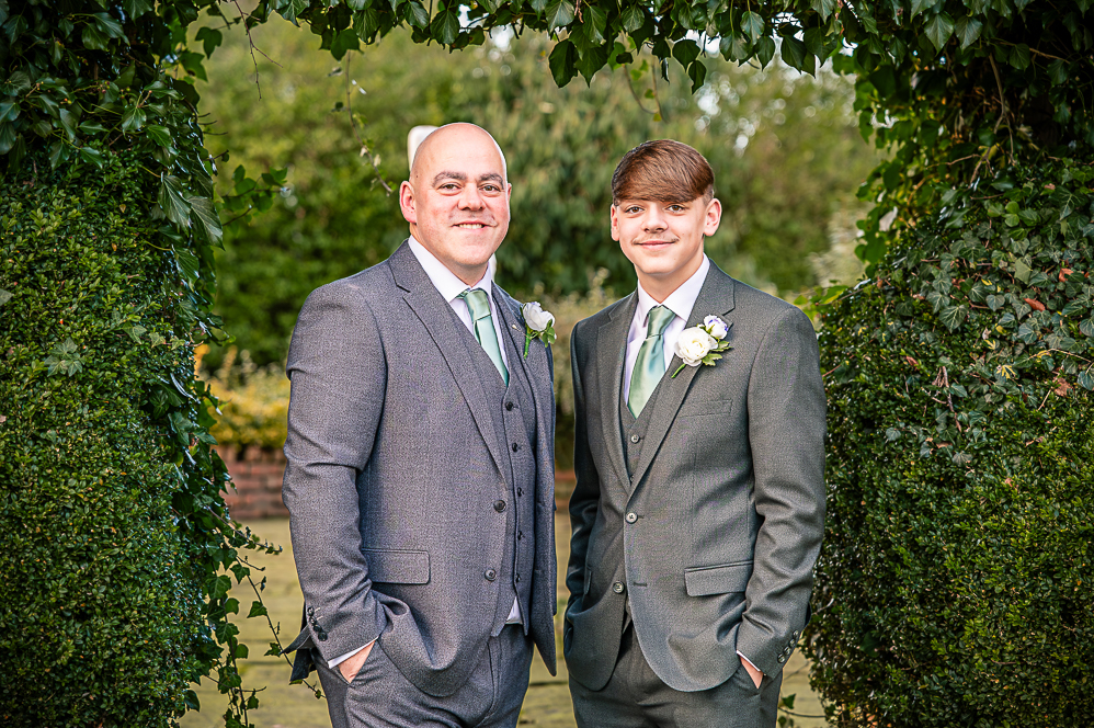 Groom and best man under a leaf shaped arch taken by Manchester Photographer Wedding Rebekah Morecroft