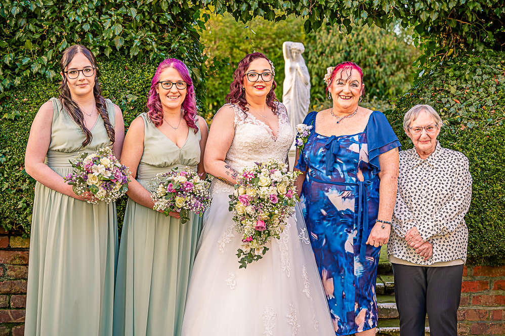 Bride, 2 bridesmaids, mother of the bride and nanna under a leaf shaped arch taken by Manchester Photographer Wedding Rebekah Morecroft