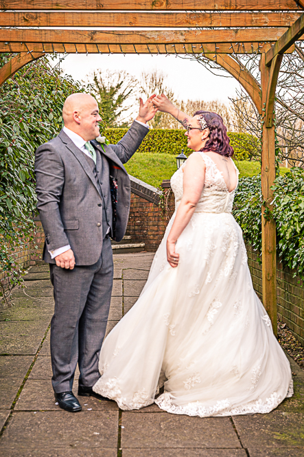 Bride and Groom dancing under a gazebo