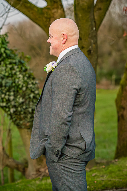 Groom smiling as he looks a bride (not in the picture)