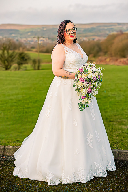 Side view of Bride and her Bouquet and hills behind