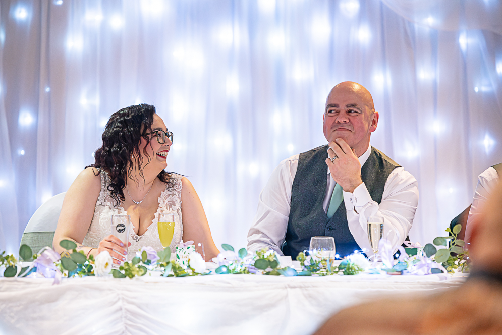 Bride and groom reacting to speeches