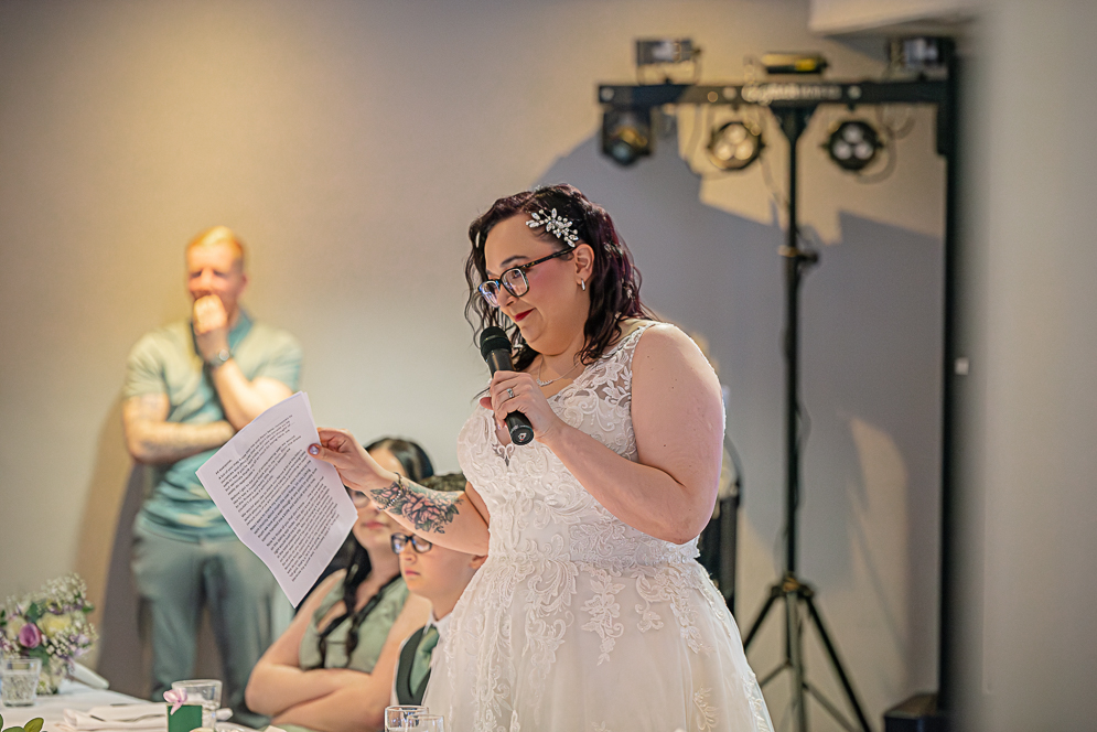 Bride giving her speech holding her notes