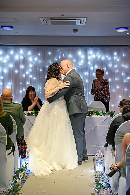 Wedding Photo Tips – The First Kiss Bride and groom sharing their first kiss during a Manchester wedding ceremony with a natural, relaxed style