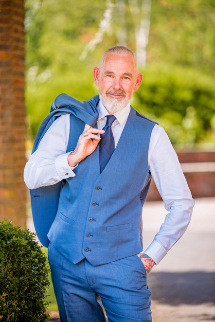 Man with suit jacket over his shoulder