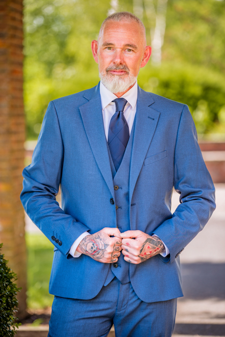 Man holding the front of his suit jacket