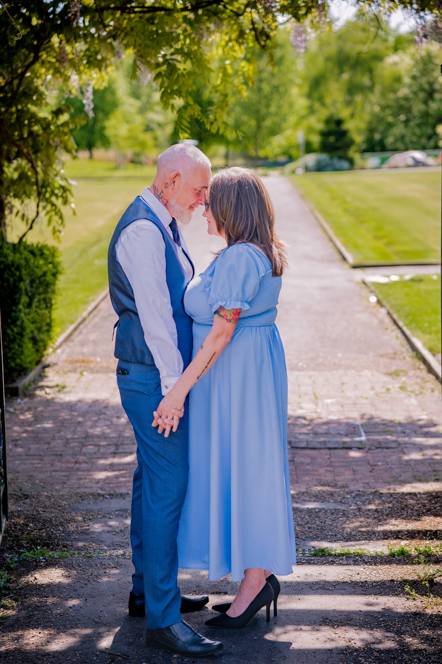Couple's head touching and hands holding Alexandra Park in Oldham