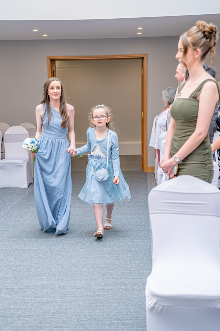 Bridesmaid and flower girl walking down the aisle