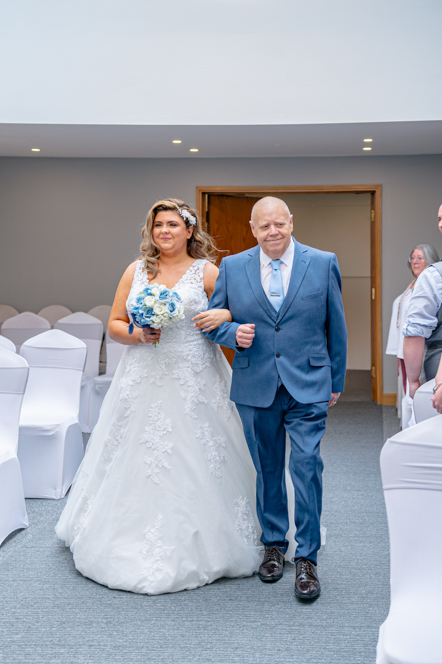Bride being walked down the aisle with father of the bride