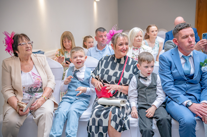Group of wedding guests sitting in their chairs
