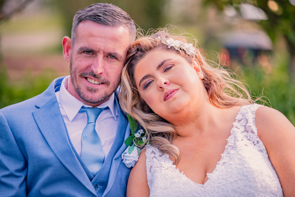 Bride leaning head on Groom’s shoulder