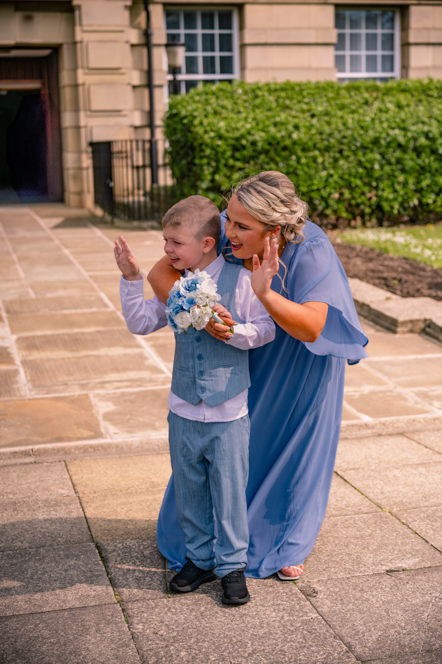 Child reacting with excitement as the bride arrives at a Bury wedding ceremony.