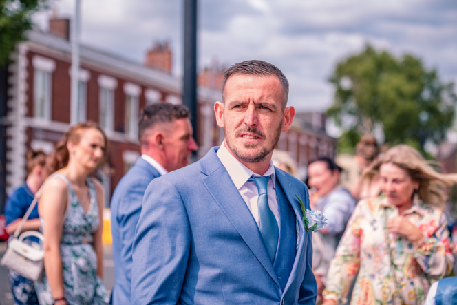 Wedding guests arriving outside Bury Town Hall before a registry office wedding.