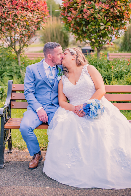 Natural moment between bride and groom during wedding portraits in Bury.
