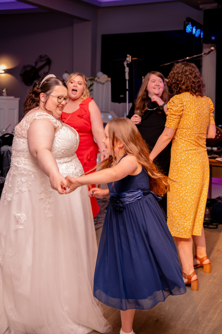 Bride dancing with guests at wedding reception