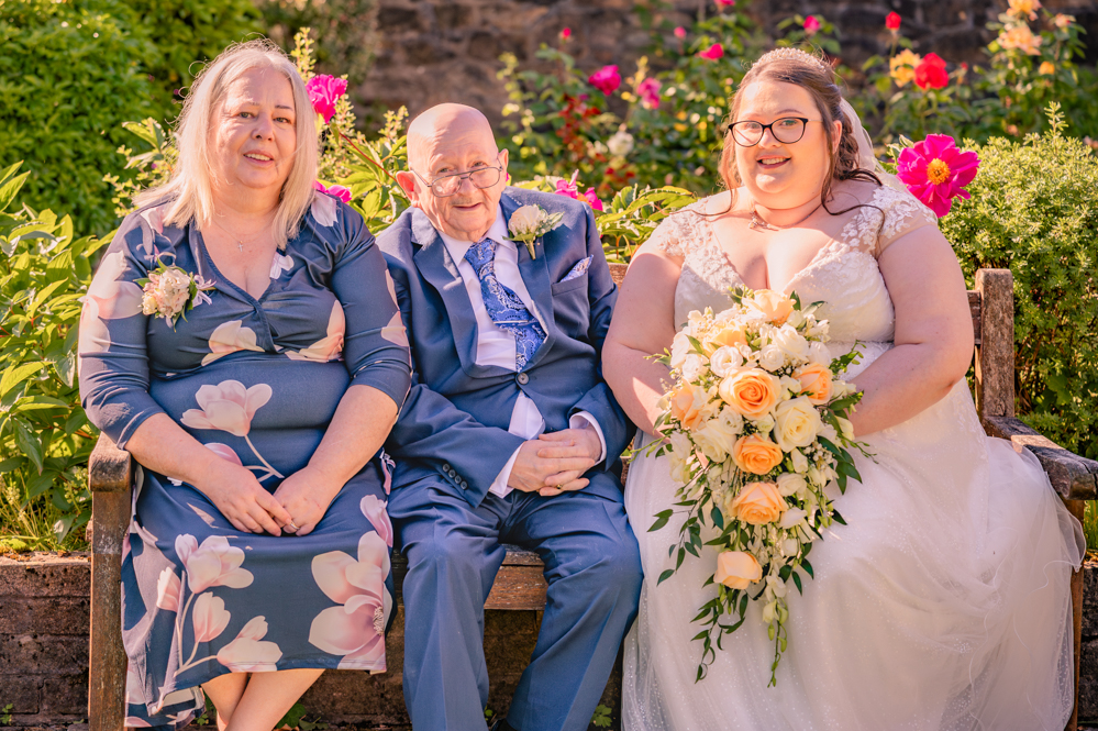 Bride with her parents at church wedding in Bury