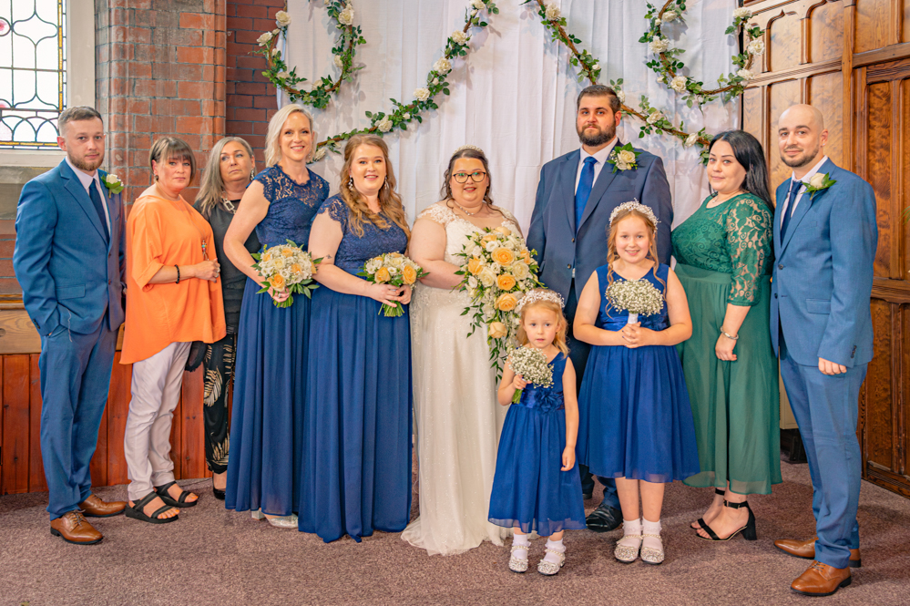 Bride and groom with bridal party and the bride's siblings