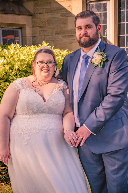 Bride and groom showing off their wedding rings