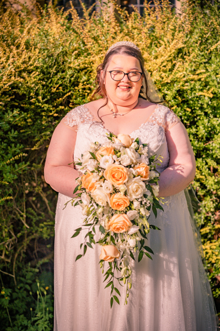 Close-up of the bride with her bouquet of flowers smiling