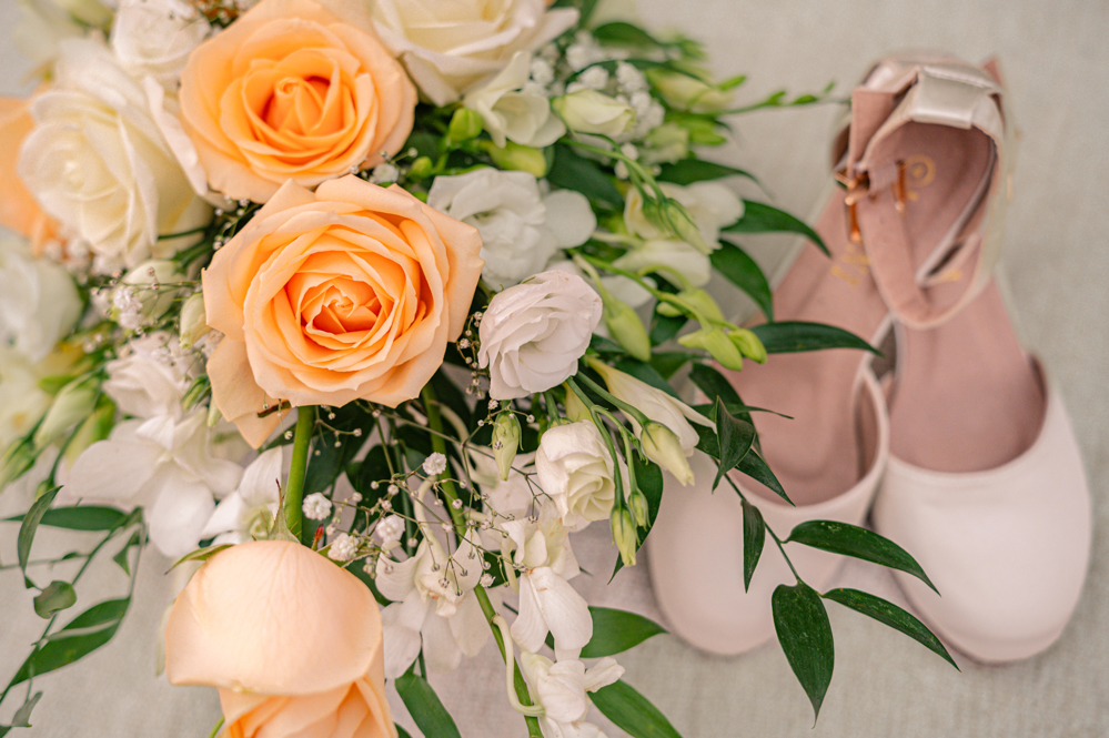 Close-up of the bride shoes and bouquet