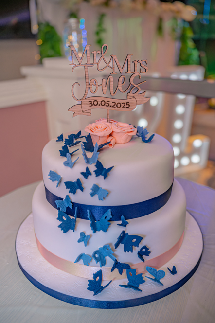 Wedding cake with blue butterflies and peach flowers