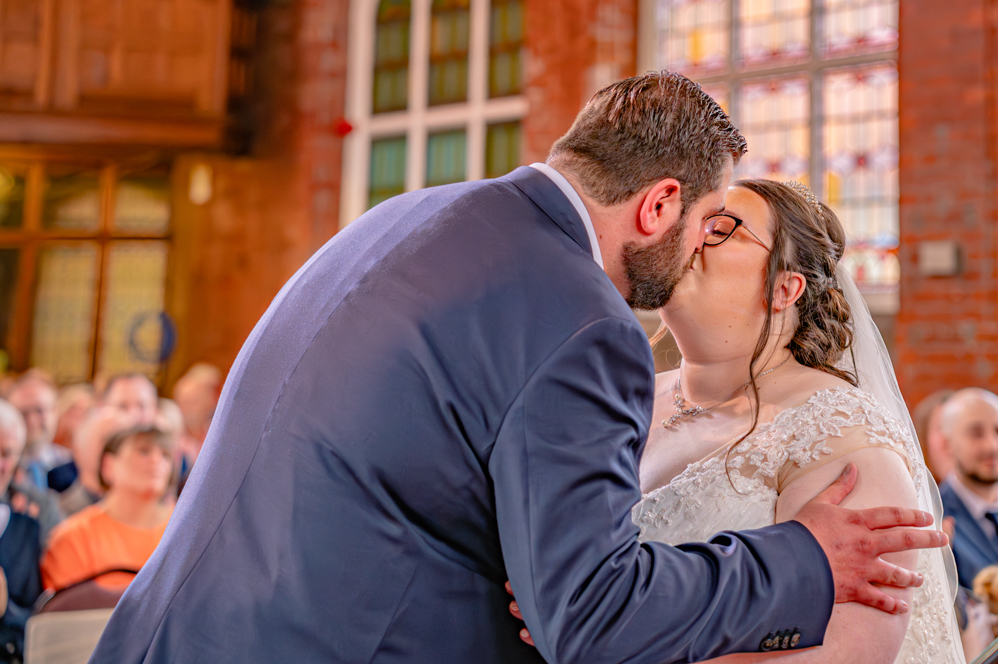 Bride and groom first kiss at Metro Christian Centre wedding