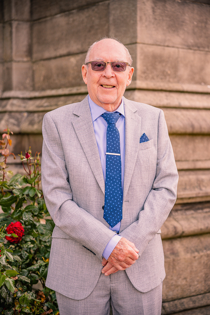 Older man smiling outside St Peter’s Church before the vow renewal ceremony
