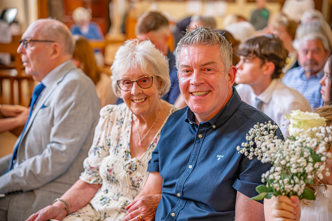 Mother and son seated during the vow renewal ceremony at St Peter’s Church
