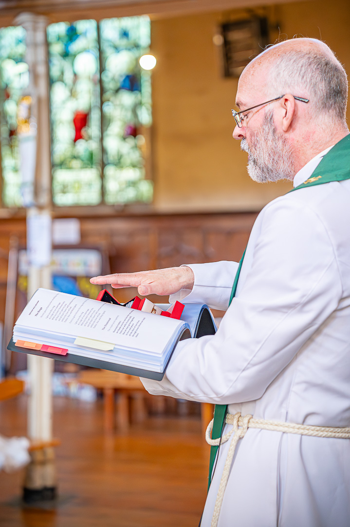 The vicar blessing the wedding rings during the ceremony