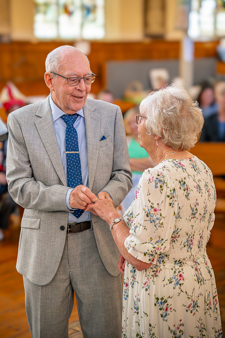 Dennis placing the ring on Patricia’s finger
