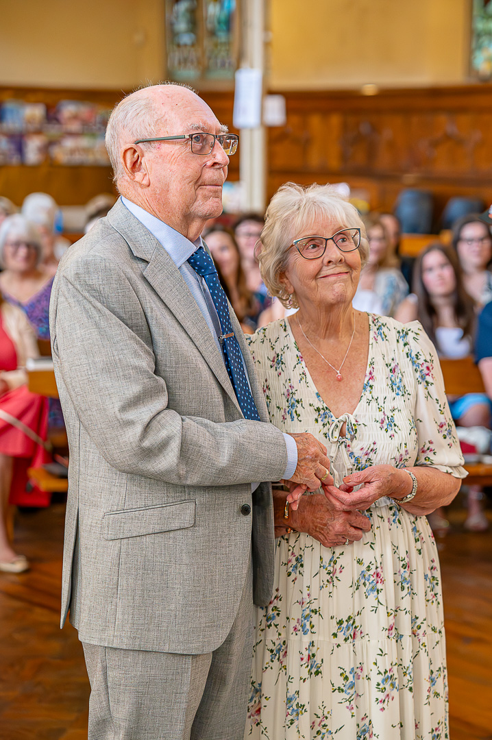 Exchanging rings during their 70th wedding celebration at St Peter’s Church, Ashton-under-Lyne, traditional Christian wedding ceremony