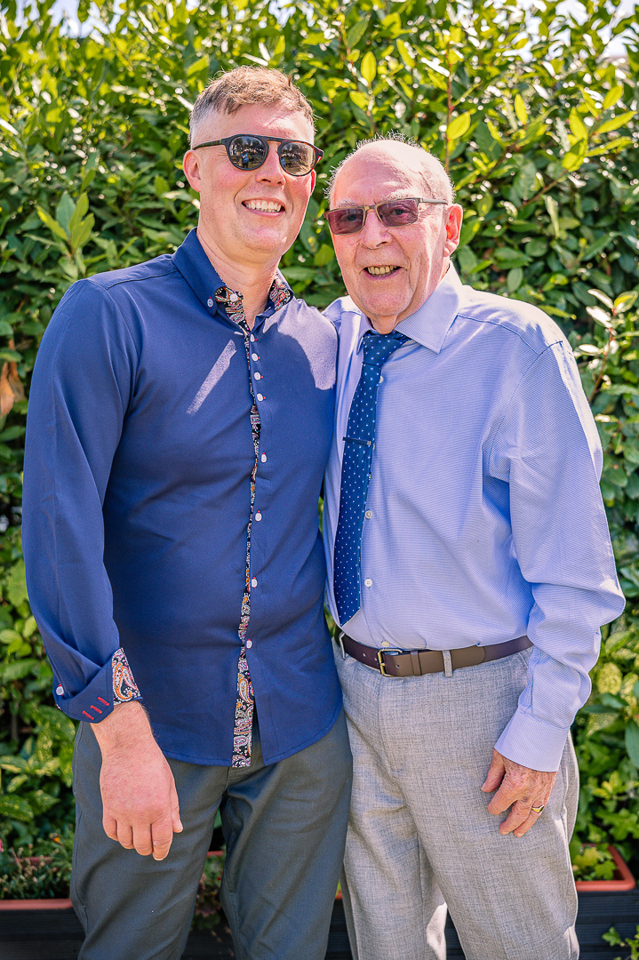 Portrait of Elderly Grandfather and her adult Grandson.