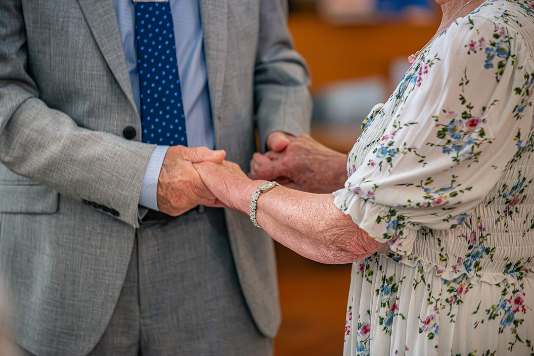 Close-up of newly exchanged wedding rings during a 70th vow renewal ceremony