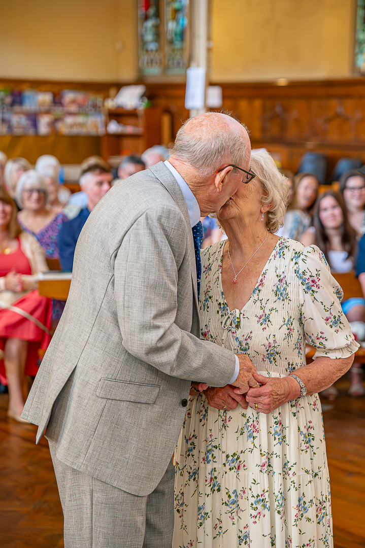 Dennis and Patricia sharing a kiss after renewing their vows