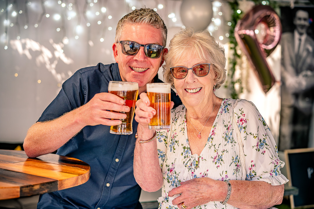Mother and son raising their drinks together in celebration.