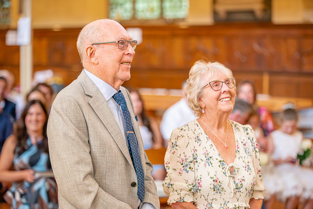 Dennis and Patricia standing together at the front of the church