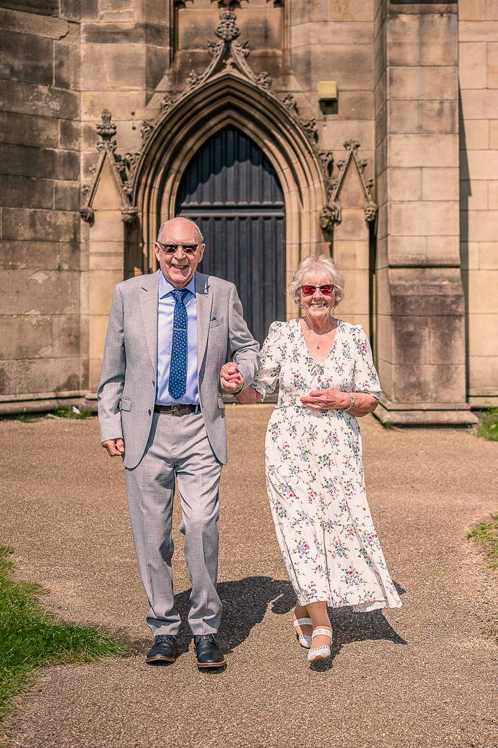 Walking hand in hand after renewing their vows